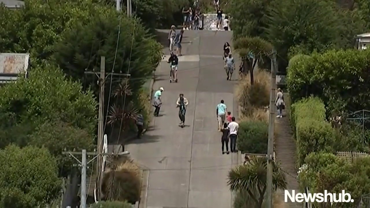 Man speeds Lime scooter down world's steepest street in Dunedin, New Zealand | Newshub