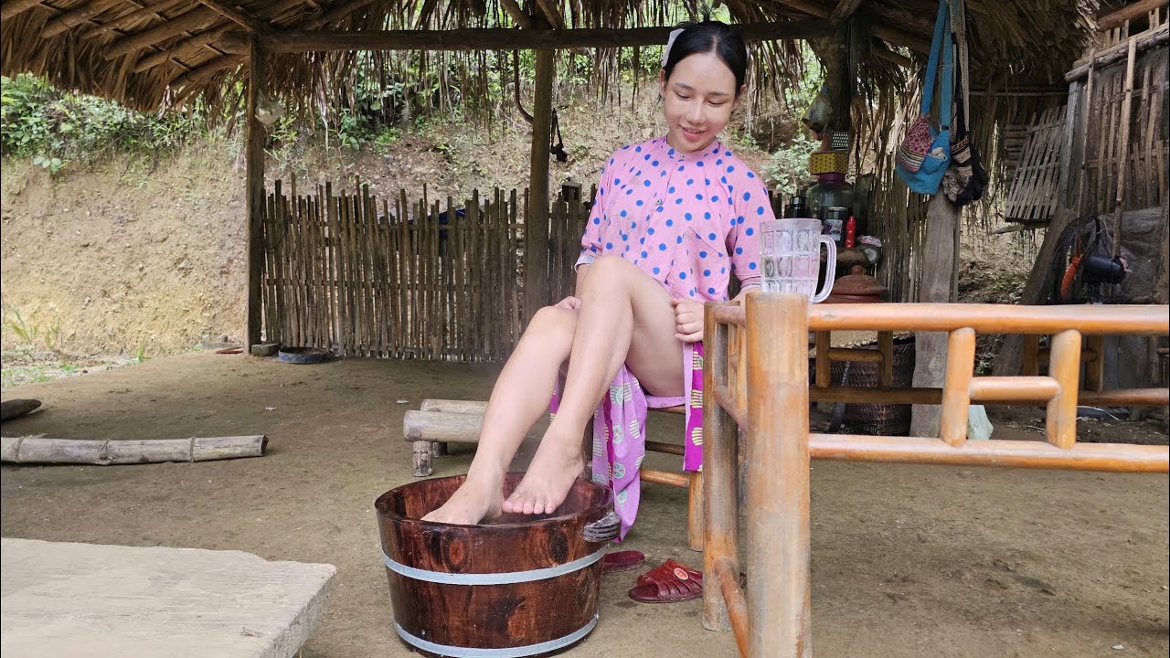 Young girl living alone at the end of the village, cures leg pain with forest medicine