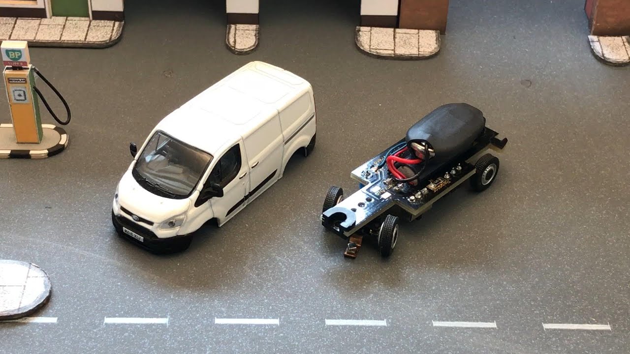 Oxford Diecast Ford Transit Custom vans running on the Faller Car System
