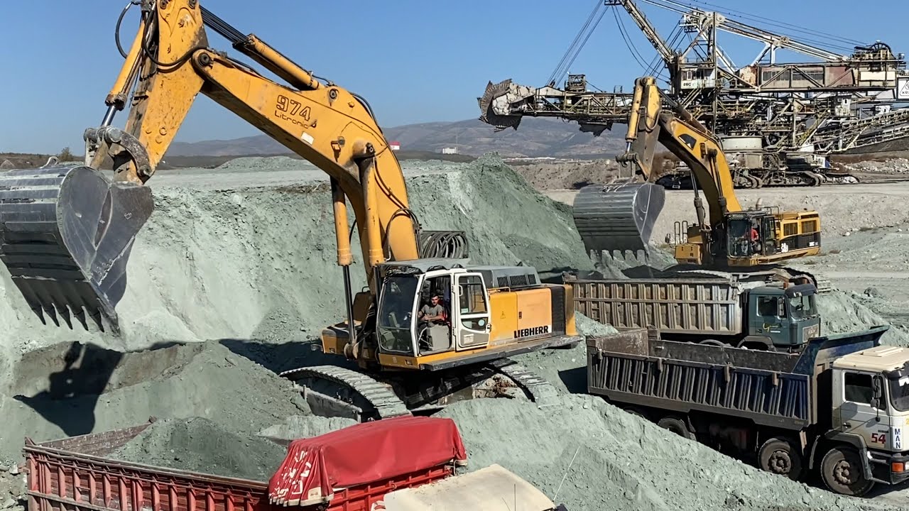 Liebherr 974 Excavator And Caterpillar 385C Excavator Loading Trucks