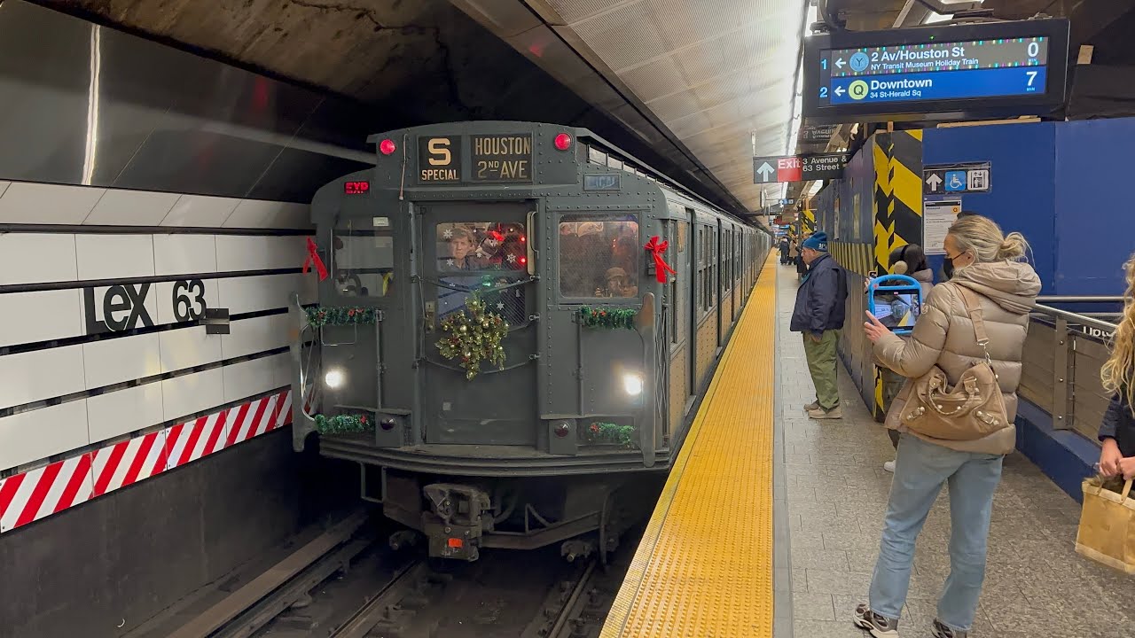 Second Avenue bound R1-9 Holiday Train arriving and leaving Lexington Av-63st 