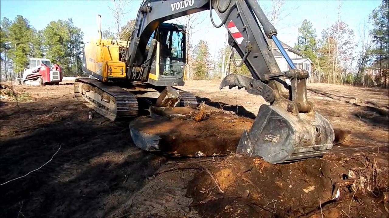 Volvo 140 Excavator Wrestles Massive Boulder