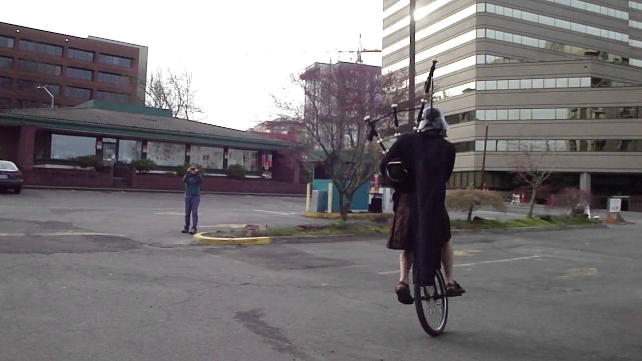 The Unipiper: Dart Vader playing the bagpipes on a unicycle