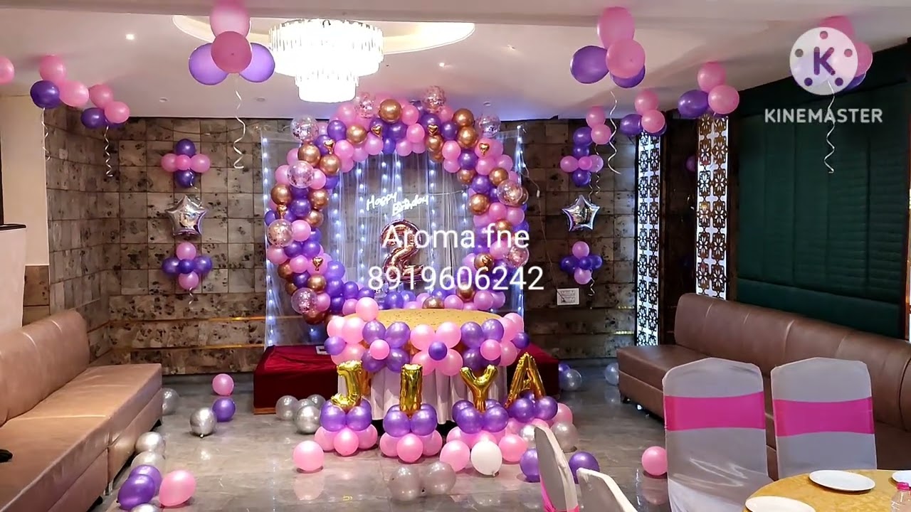Birthday party decoration for baby girl with pink and purple theme