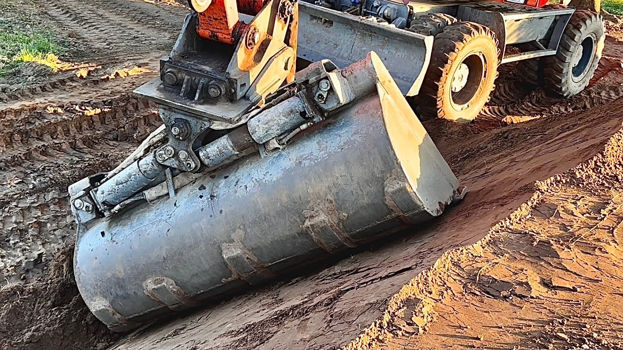 Right Bucket for the Job! Terex 1605M Atlas Excavator is Building Dirt Wall as a Landscape Feature. 