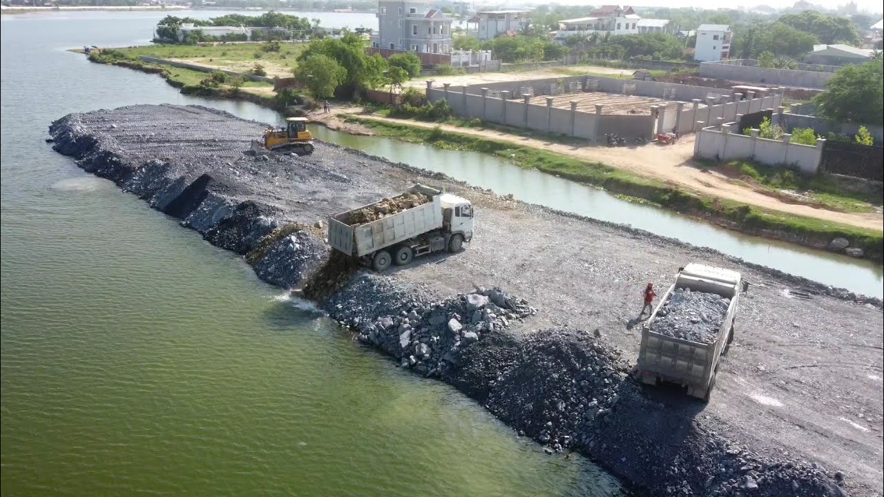 Good job Top project showing Mighty dozer  pushing Filling Stone with super Dump truck dumping Stone