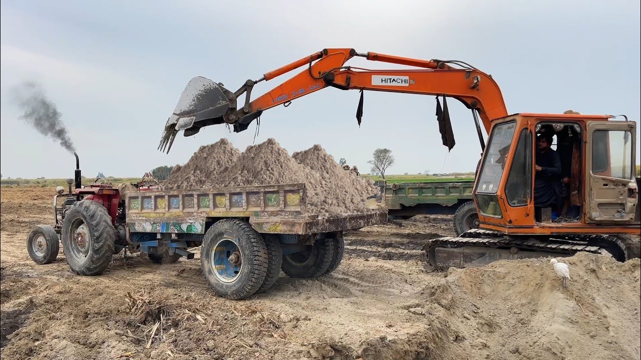 Excavator Loading Sand on 240 Tractor Trolley