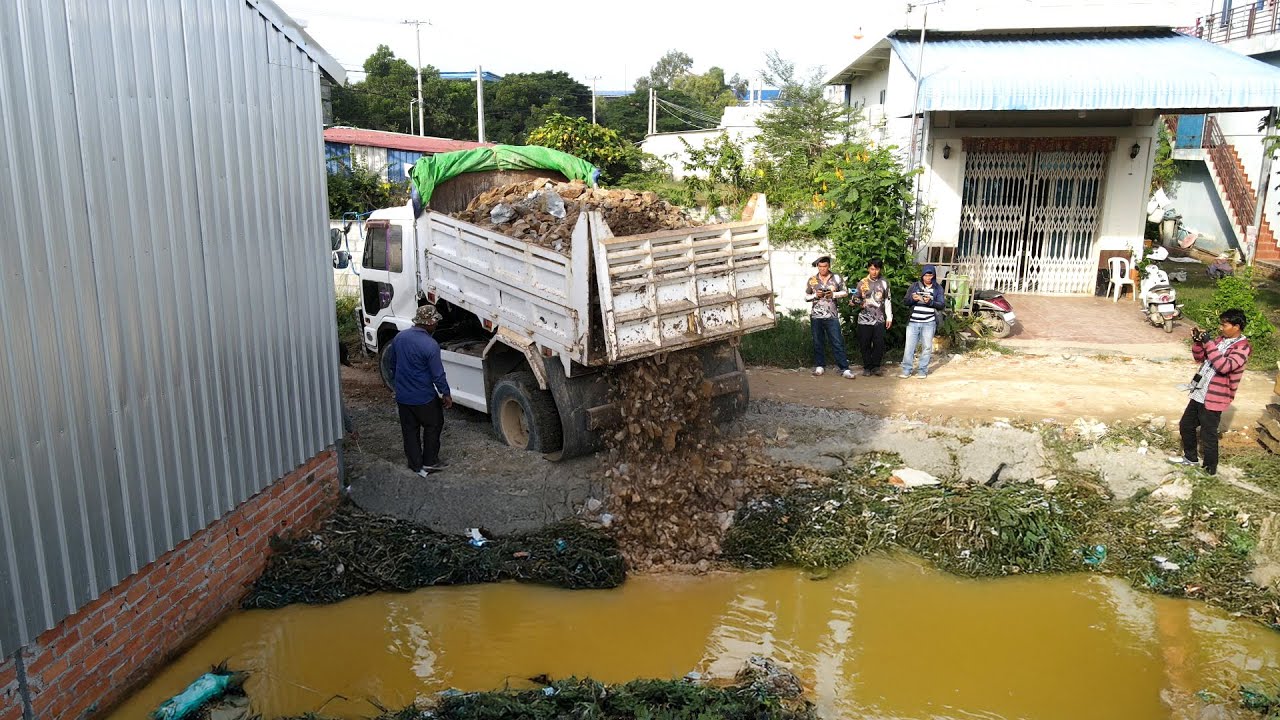 Awesome Bulldozer and Trucks Start Amzing Work to Pushing Rock to the diety Aquatic plants and sewag