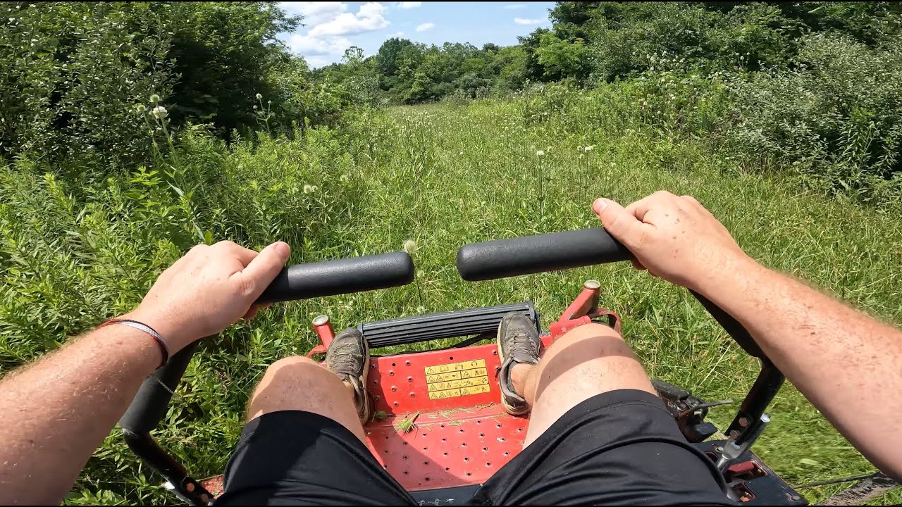Toro Z Master plowing through an overgrown field and trails on old tree farm