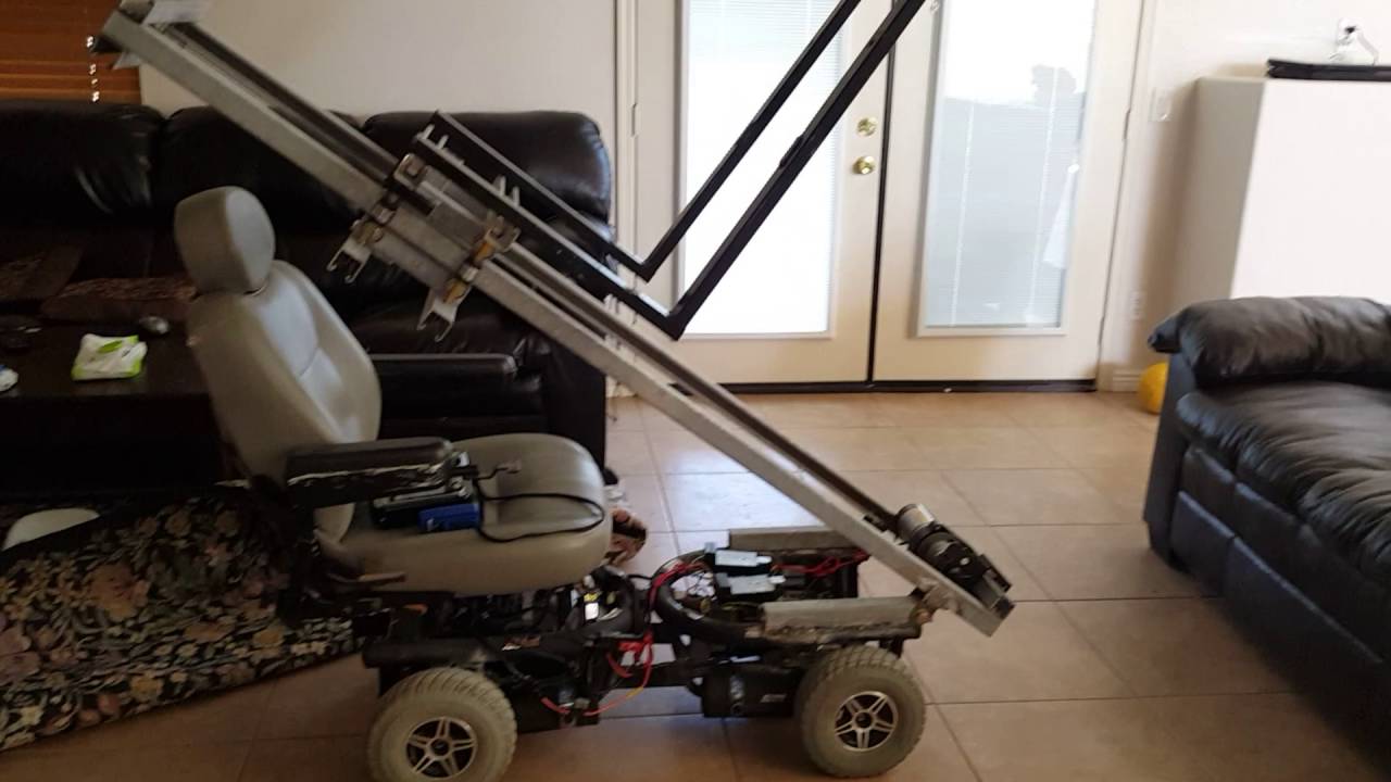 Scratch built mini  4wd wheelchair forklift lifting a couch