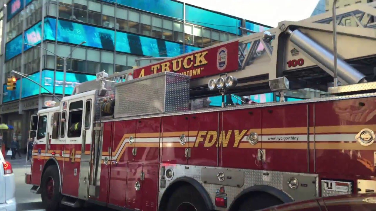 FDNY LADDER 4 GIVES ME A WAVE WHILE RESPONDING URGENTLY WITH LOTS OF AIR HORN ON WEST 50TH STREET.