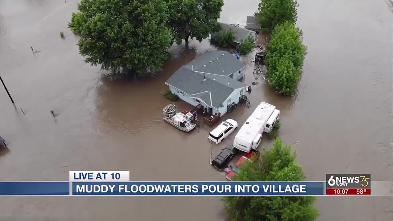 Muddy floodwaters pour into small Nebraska town