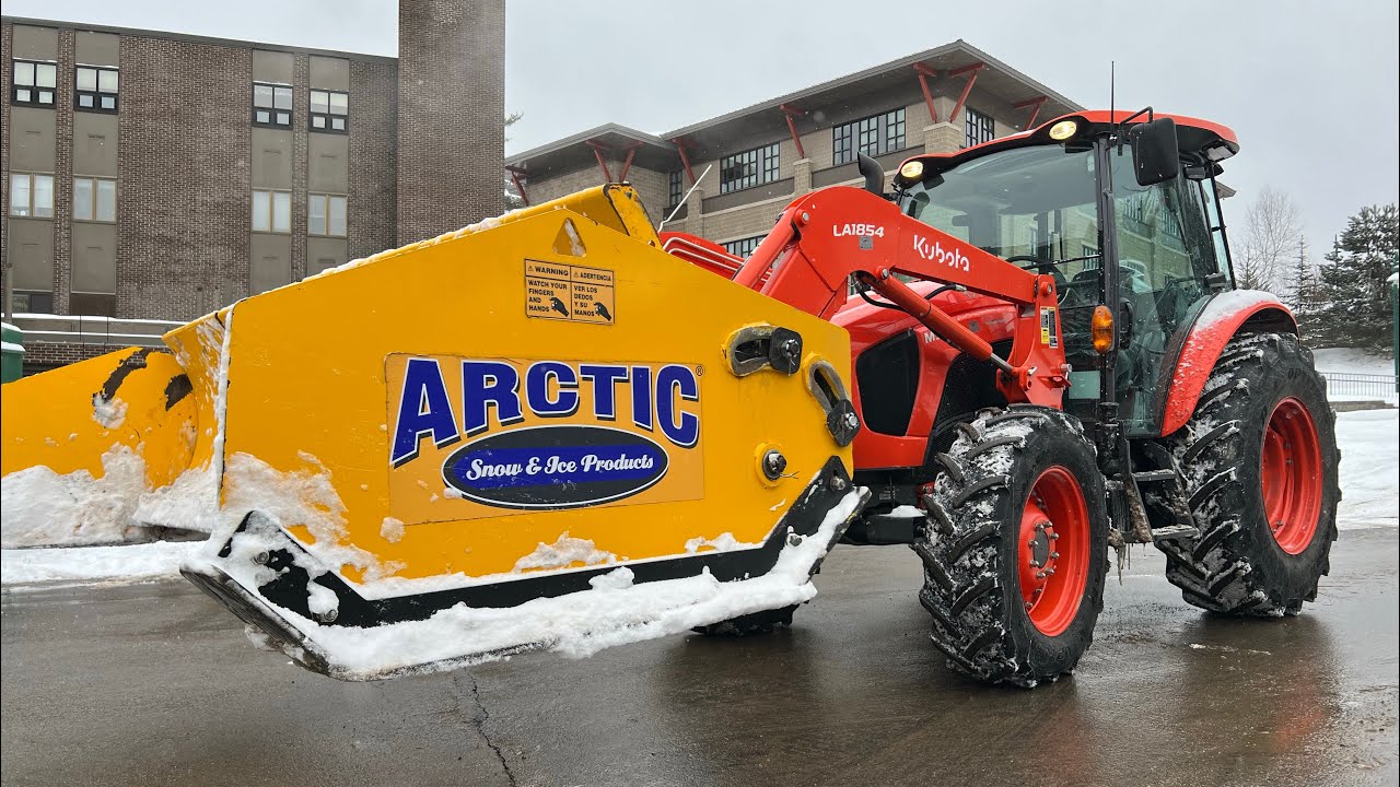 Tractor snowplowing with arctic pusher