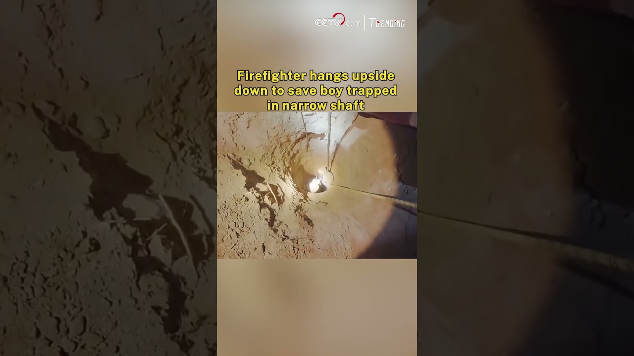 Firefighter hangs upside down to save boy trapped in narrow shaft