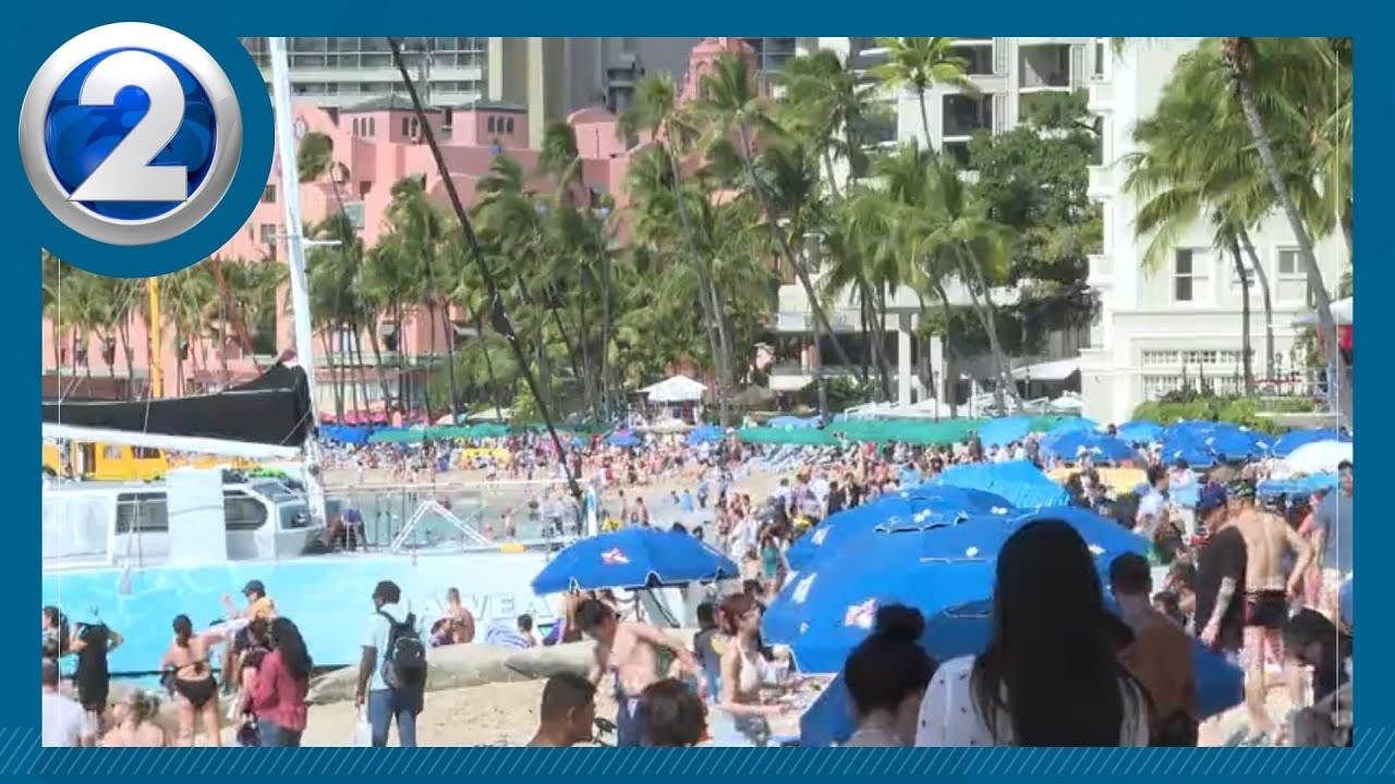 Visitors pack Waikiki Beach on Christmas Day, a sign tourism closing year out strong