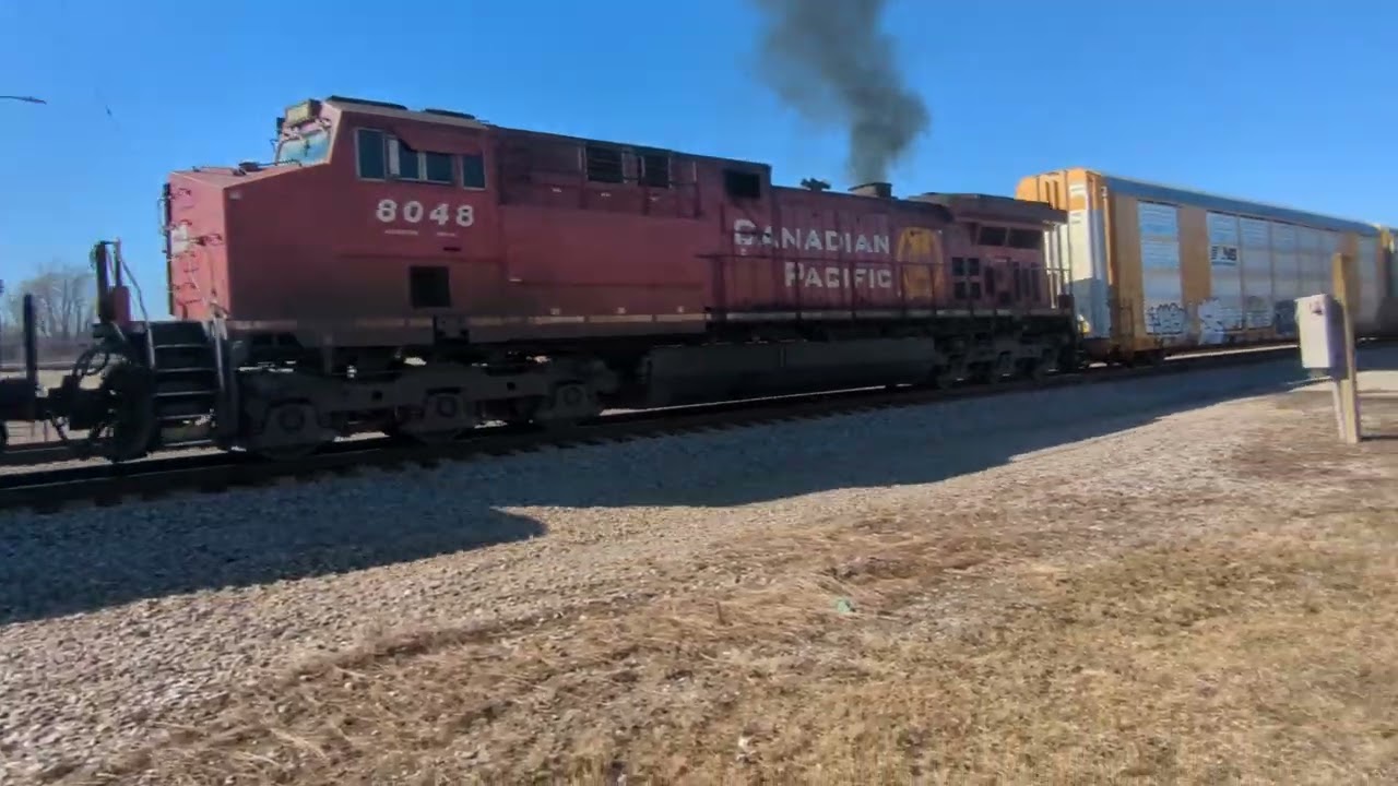 CPKC 247 with mid train DPU working hard. Massive train.