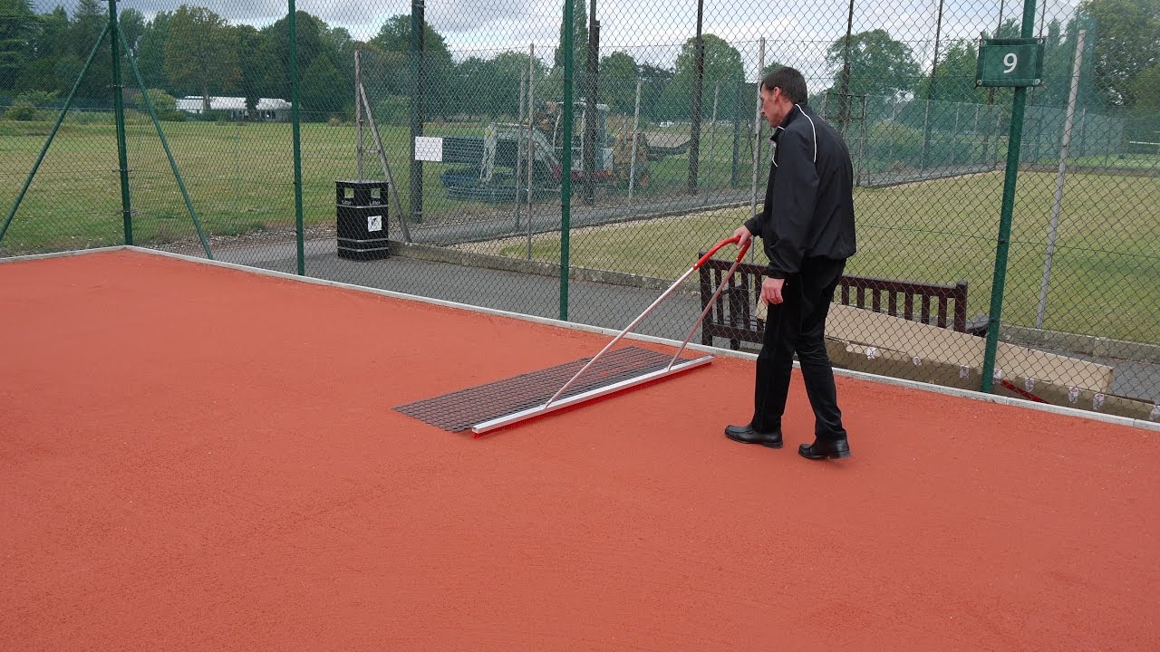 Artificial Clay Tennis Court After Play Maintenance
