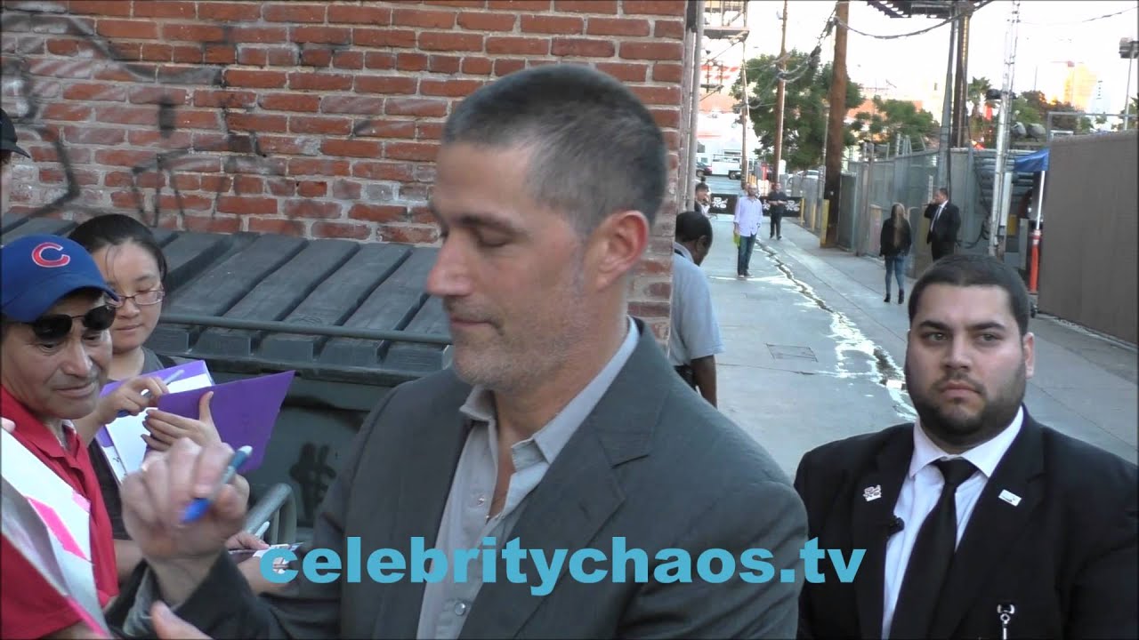 Actor Matthew Fox signs a bobblehead while greeting fans outside jimmy kimmel live