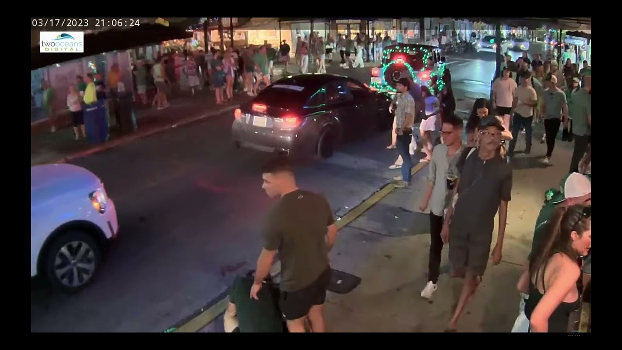 friends assist man who cannot stand/walk. Another interesting key west street scene