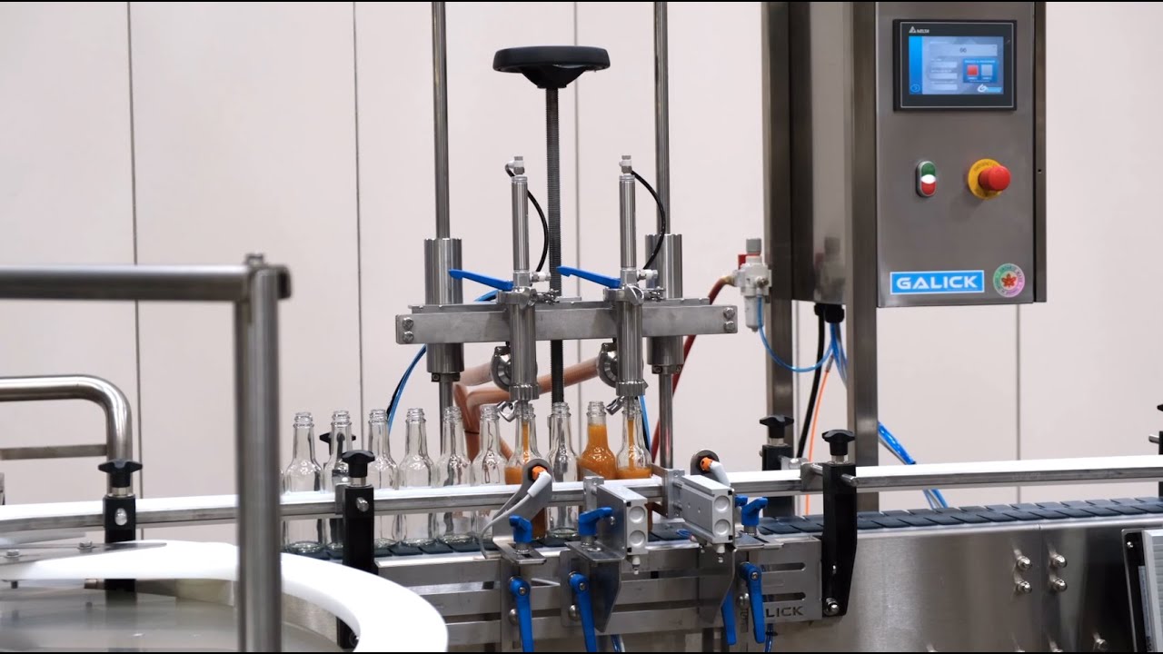 Hot Sauce Packaging Line. Filler, Capper, Labeler, Neck Bander and Heat Tunnel