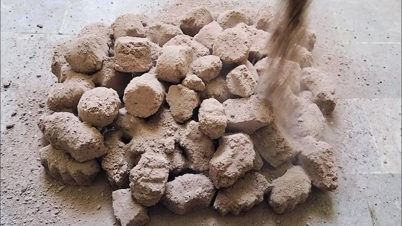 Crispy Red grainy chunks dry floor crumbling dust play and water crumbling 