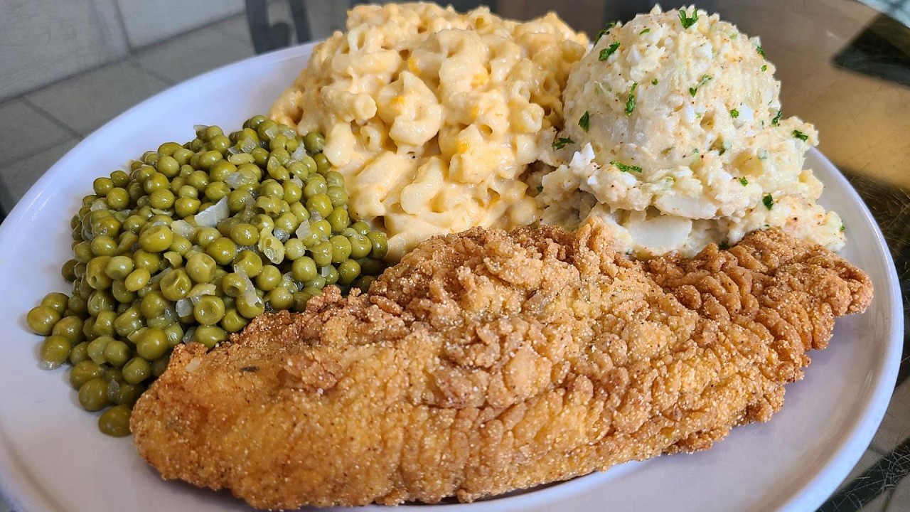 Fried catfish baked macaroni green peas and potato salad