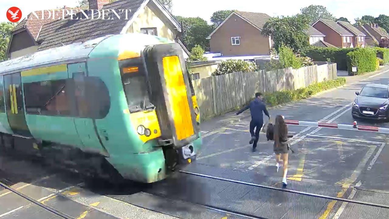 'Reckless' pedestrians seconds away from being hit by train in terrifying level crossing CCTV