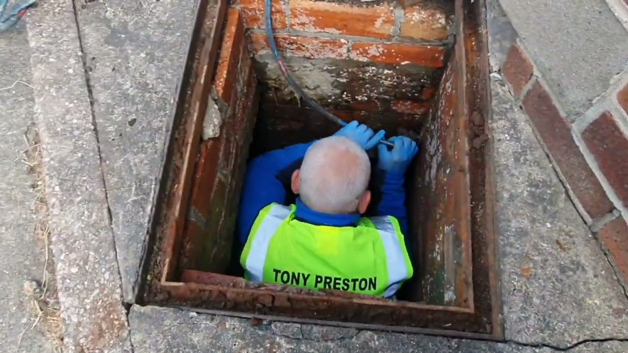 Man goes into manhole