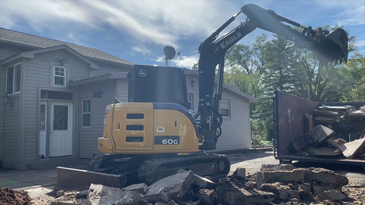 John Deere 60G Ripping Concrete