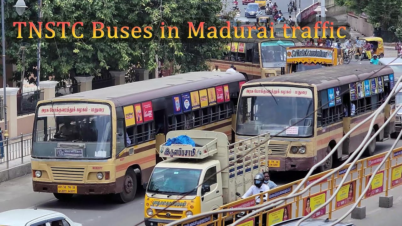 TNSTC city buses in busy Madurai traffic.