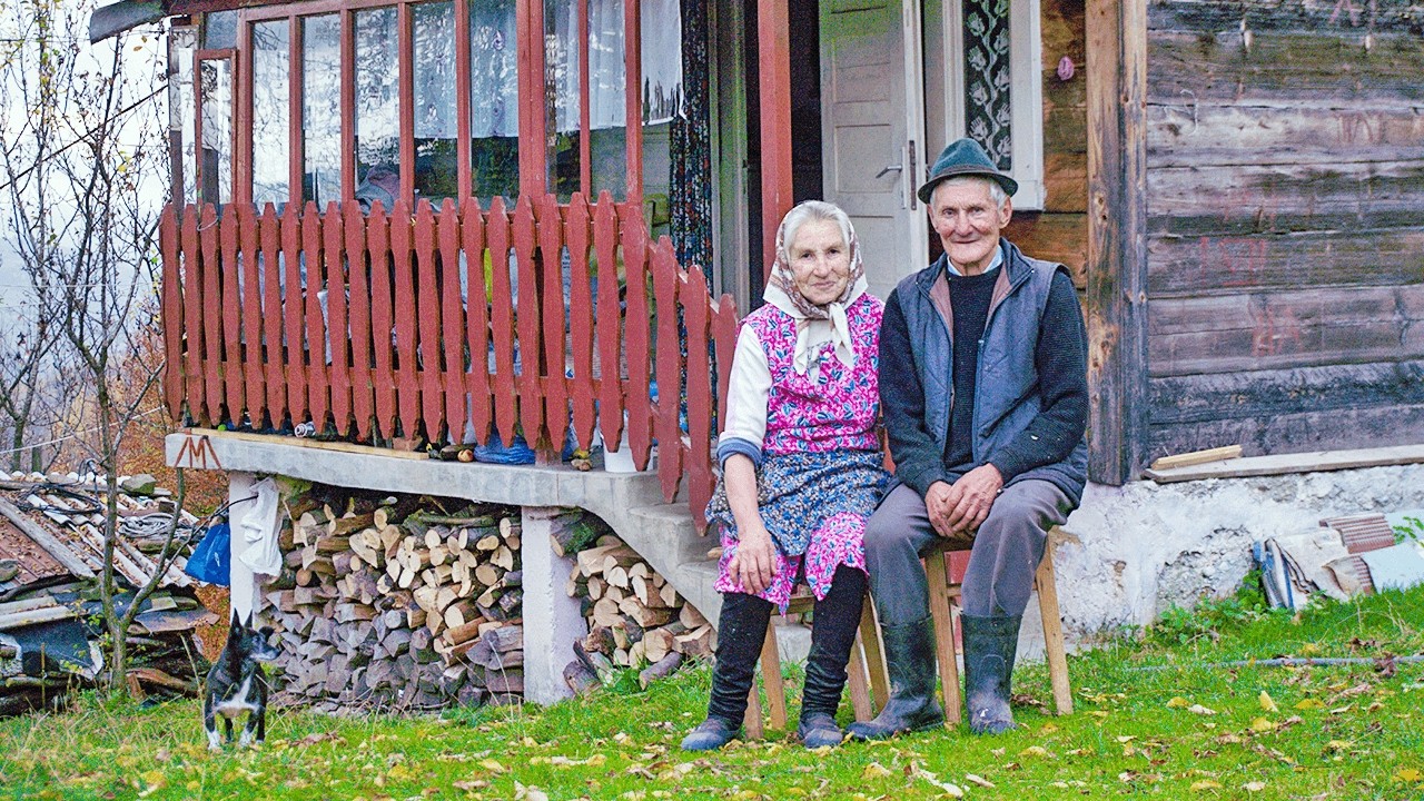 Happy old age of an elderly couple in a mountain village far from civilization