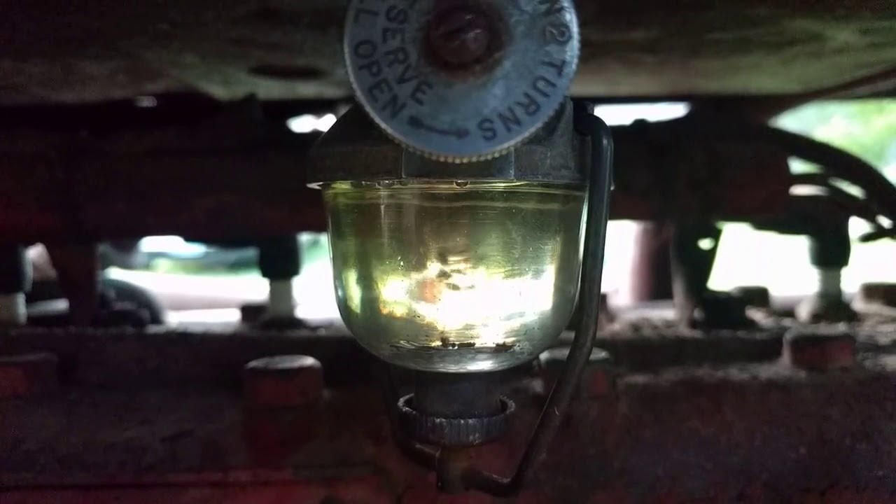 Ford 8N tractor fuel problem shown at sediment bowl