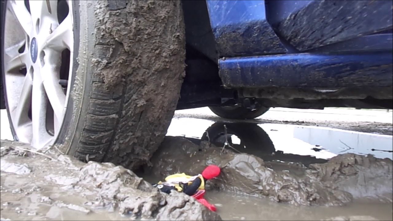 Vintage plush / stuffed Teddy crushed and destroyed under car tyres in mud