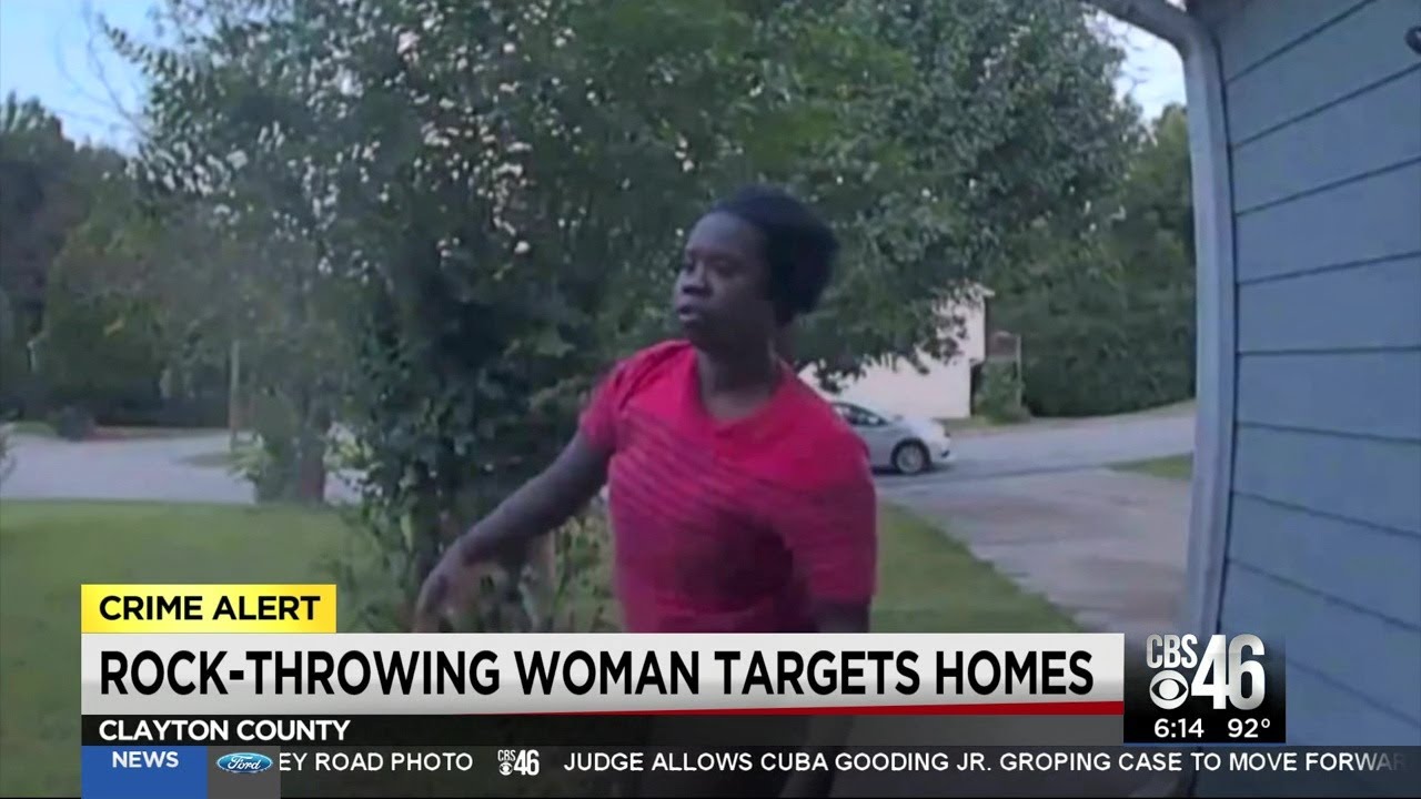 Woman caught throwing brick into home