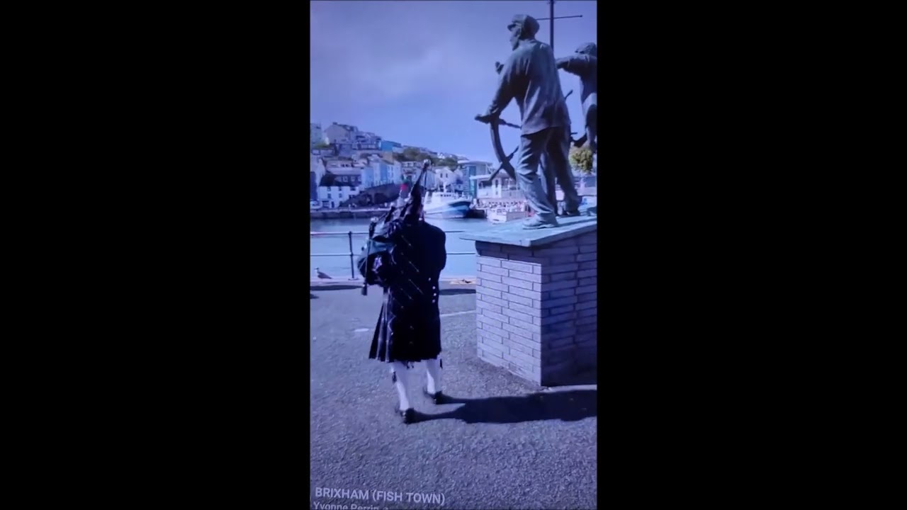 Mackenzie Moulton (Mac the Brixham piper) playing bagpipes in Brixham Devon for a,mamorial service. 