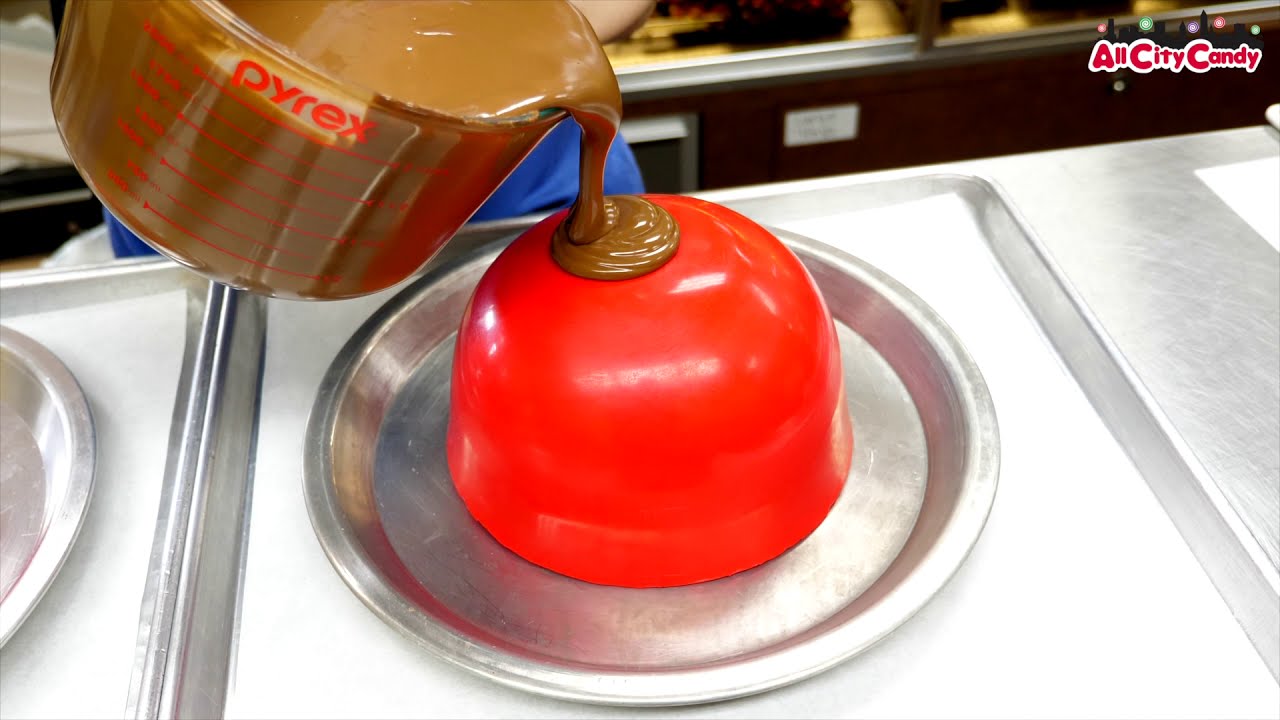 Ever Wonder How We Make Our Chocolate Bowls? Using a mold to pour milk chocolate into a bowl shape