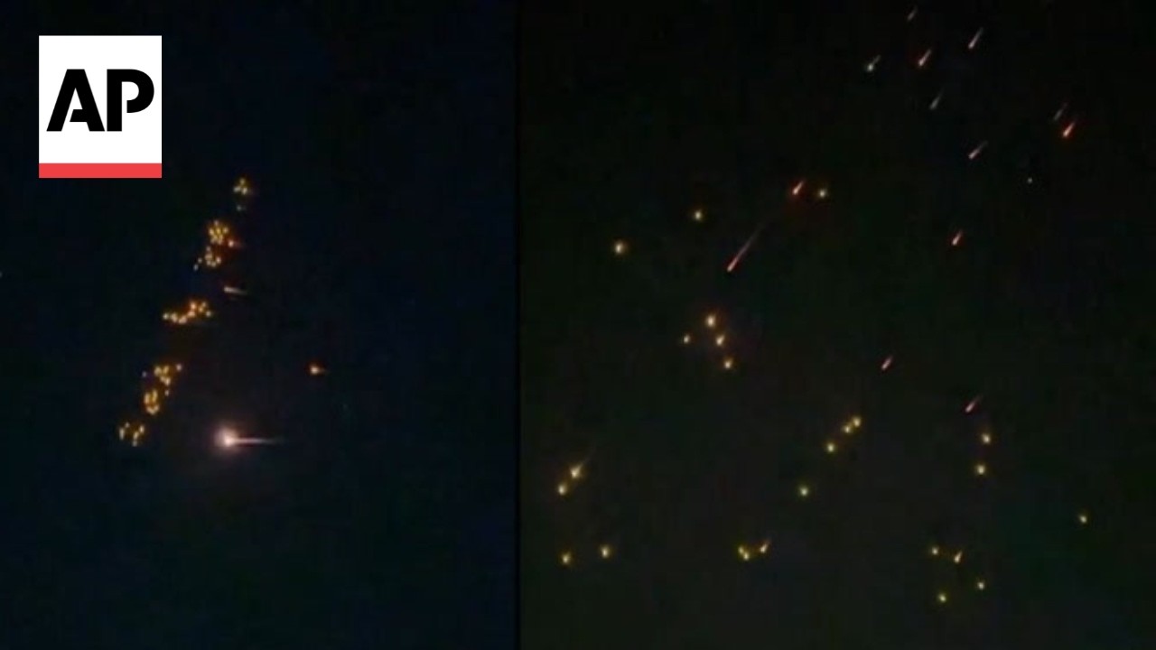 AP video shows apparent Iran ballistic missiles dropping smaller bomblets