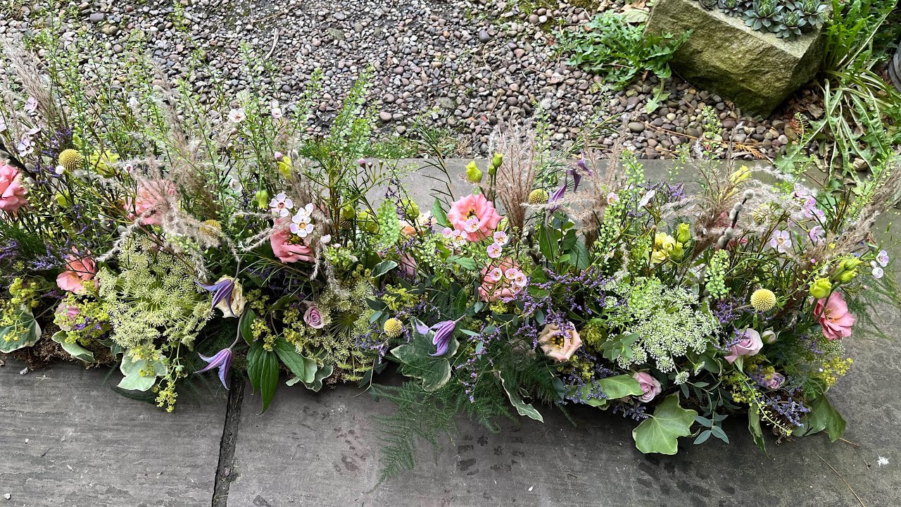 Crafting this stunning, sustainable hedgerow-style funeral arrangement.