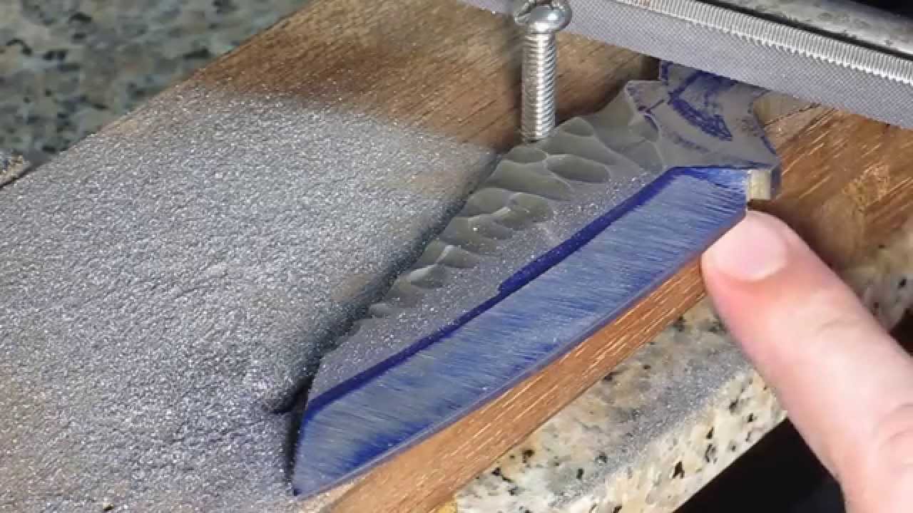 Creating a knife bevel with a file jig.
