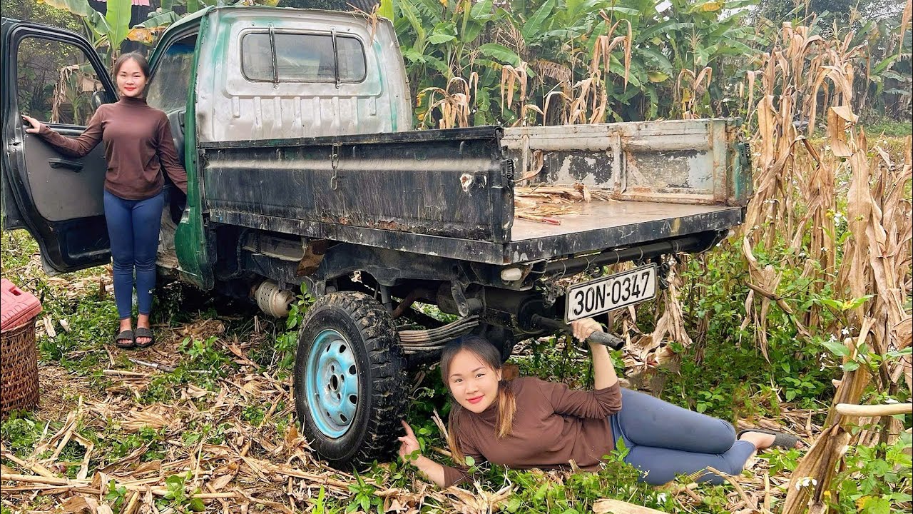 The girl repaired and restores the car engine neighbor.