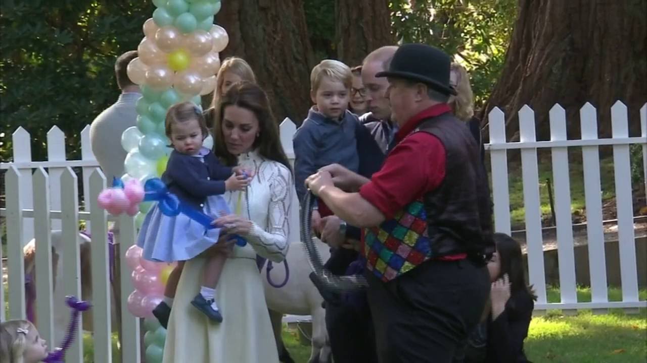 Princess Charlotte chases bubbles and Prince George plays with balloons