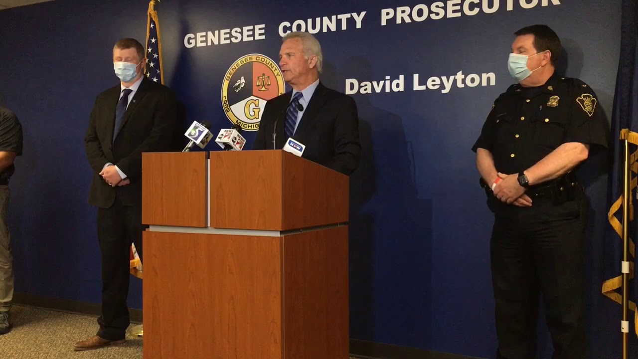 Prosecutor announces two suspects in custody in slaying of Flint security guard