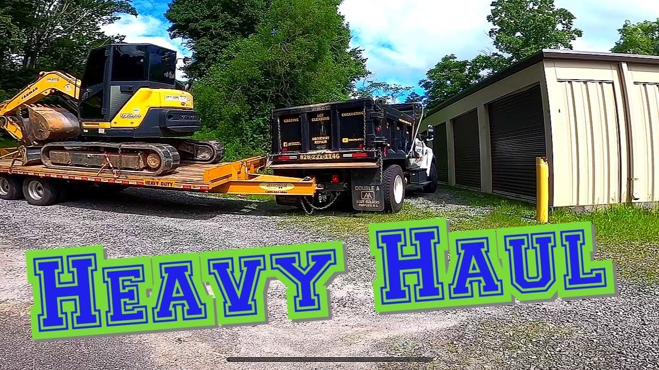 Ford F750 Super Duty Hauling Heavy Equipment And Gravel