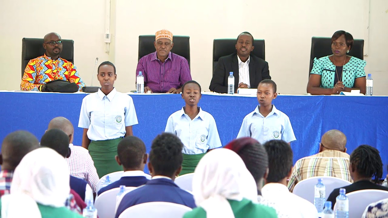 Thitani Girls students recite the Kenyan National Anthem in Dholuo