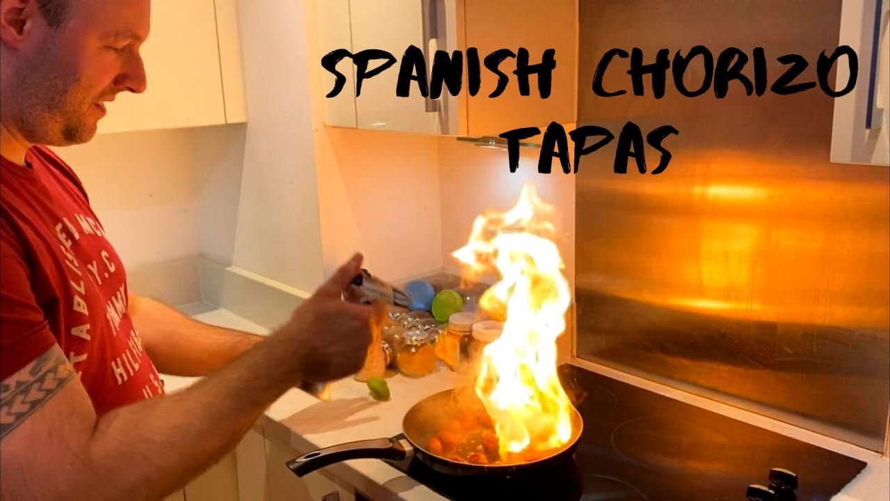 How to make tapas - Spanish chorizo tapas with baby tomatoes, olives peppers and red wine.