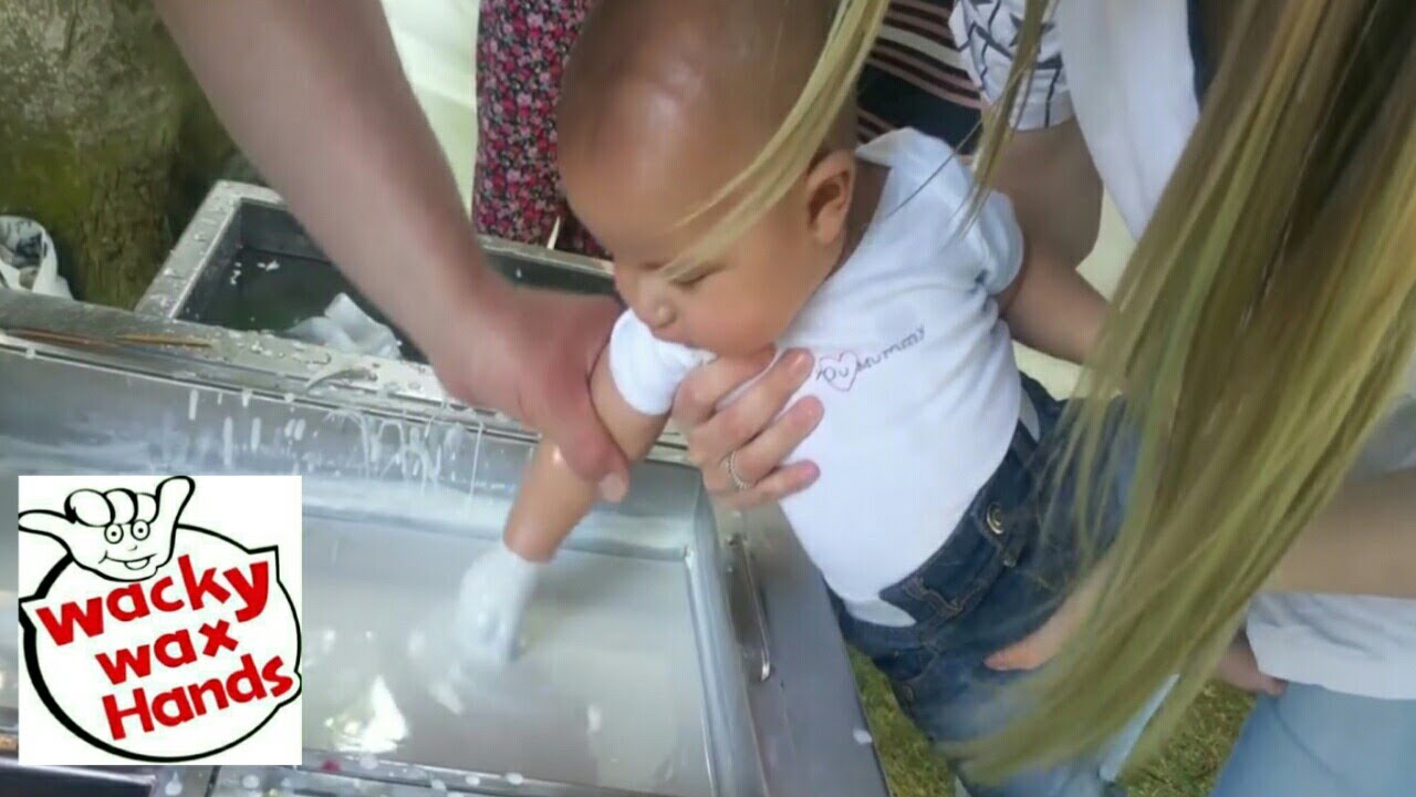 Dipping Babies Hand in Wax.   Babies keepsake idea.