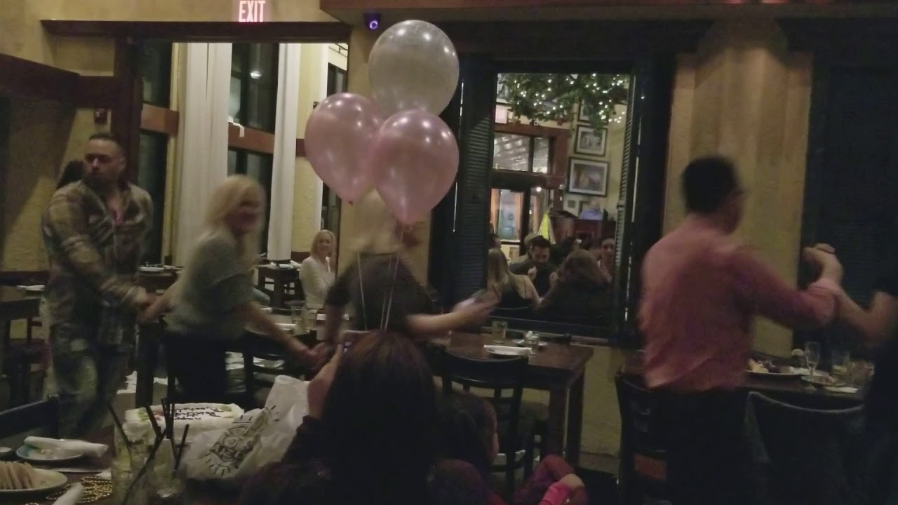 Customers doing a traditional Greek dance at restaurant 