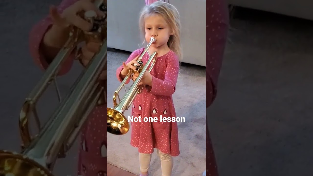 Cute little girl playing trumpet