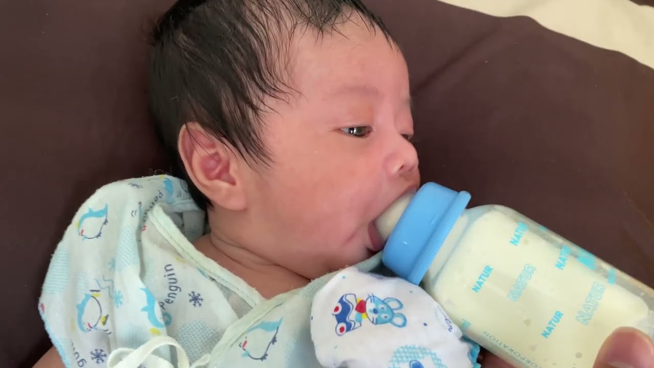 The baby is sleeping while feeding