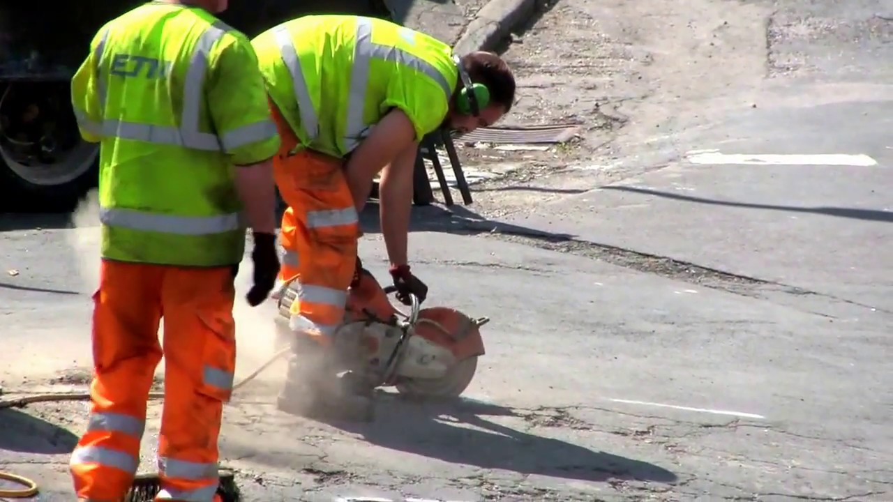 ROAD REPAIRS - Cutting away old damaged road surface (tarmac)